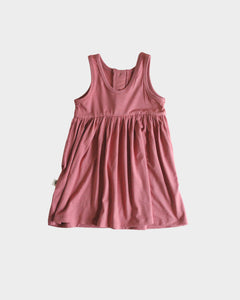 The Henley Tank Dress features a scoop back neck, gathered skirt, a functional button placket.   Fit: true to size  Features: scoop back neck, gathered skirt  Fabric: 95% bamboo 5% spandex jersey  Care: wash with like colors, gentle detergent, cool water, for best results lay flat to dry