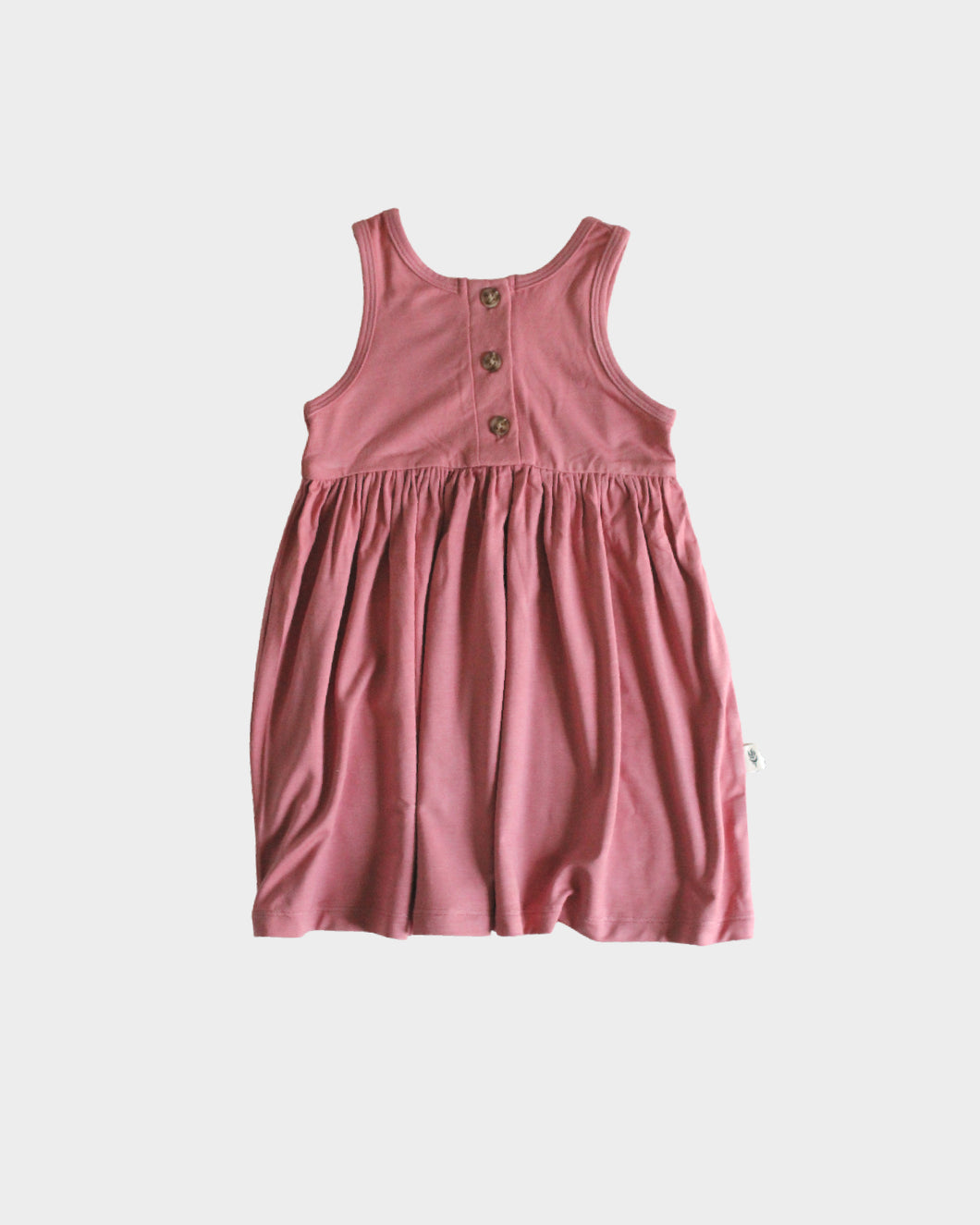 The Henley Tank Dress features a scoop back neck, gathered skirt, a functional button placket.   Fit: true to size  Features: scoop back neck, gathered skirt  Fabric: 95% bamboo 5% spandex jersey  Care: wash with like colors, gentle detergent, cool water, for best results lay flat to dry